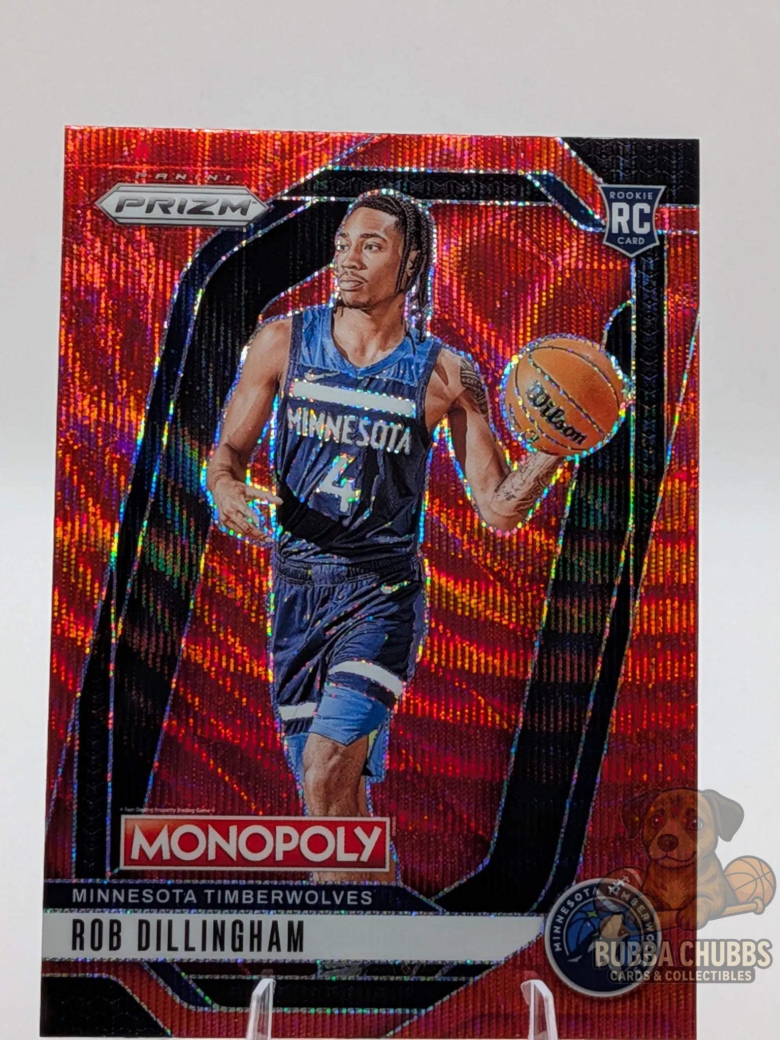 Basketball trading card featuring a basketball player rookie rob dillingham of the minnesota timberwolves panini prizm monopoly red shimmer parallel 